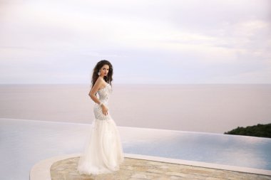 Beautiful Bride in wedding dress, outdoor portrait. Brunette ele