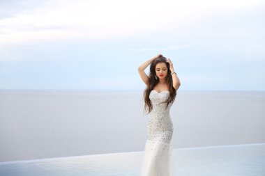 Beautiful Bride in wedding dress, outdoor portrait. Brunette ele