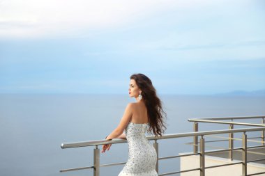 Beautiful Bride in wedding dress, outdoor portrait. Brunette ele