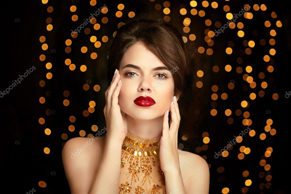Beauty girl makeup. Fashion jewelry. Elegant lady in golden dres Stock