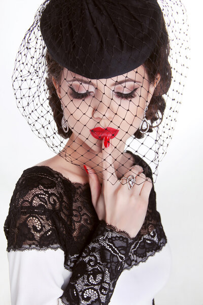 Beautiful Brunette Woman. Retro Fashion portrait in elegant hat