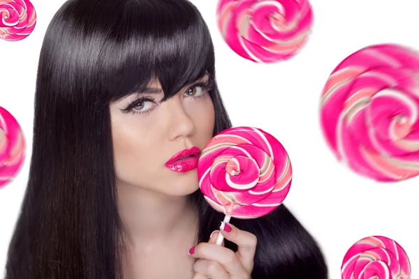 Attractive pretty girl with pink lips holding lollipop over swee — Stock Photo, Image