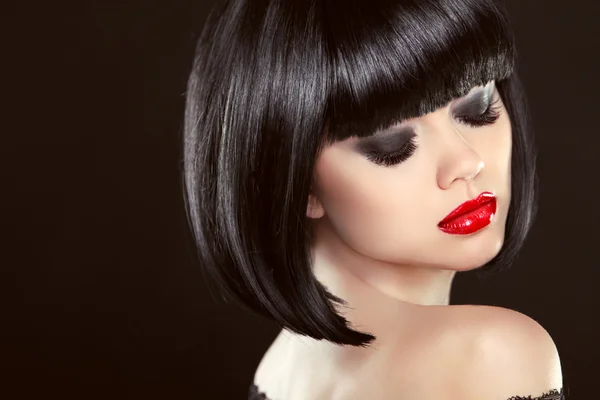 Smoky eyes makeup closeup. Black bob hairstyle. Sexy red lips. B Stock Photo