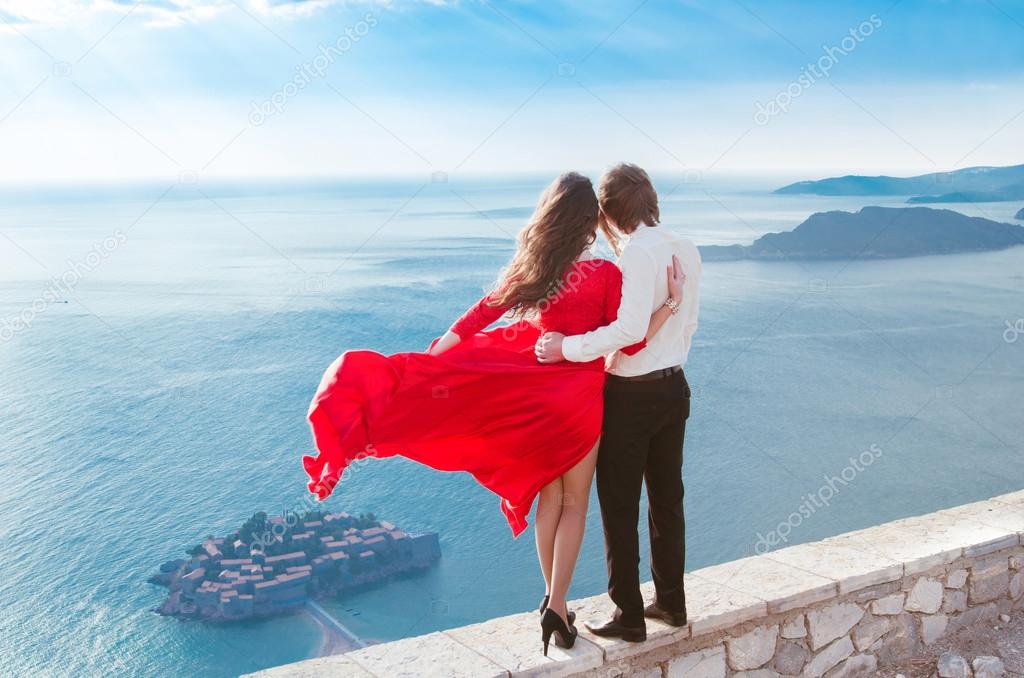 Enjoyment. Romantic couple looking on blue sea. Love. Fashion gi