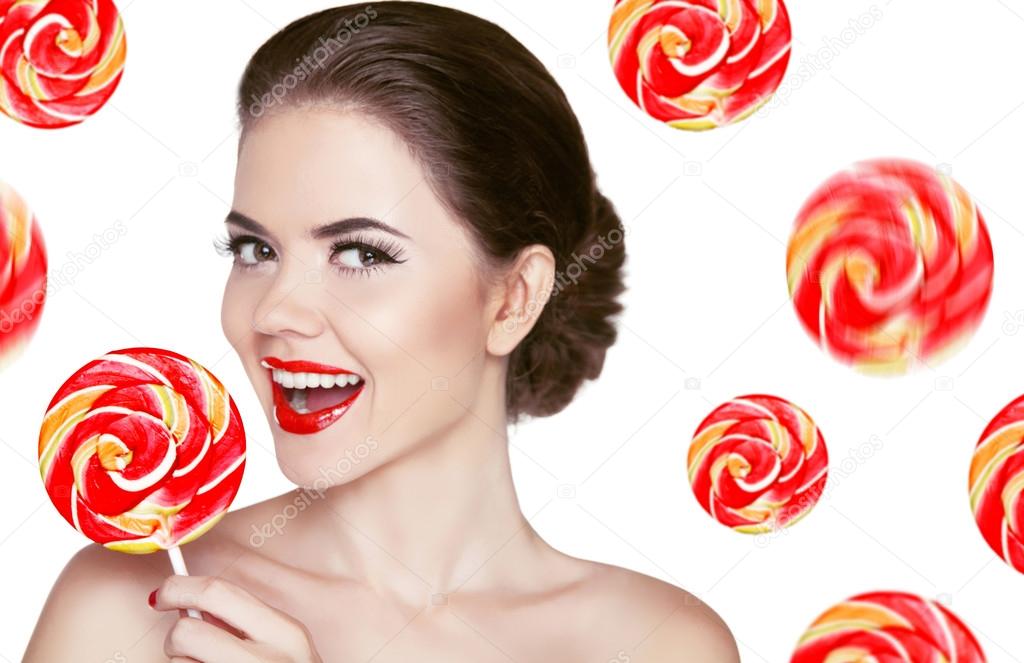 Happy smiling girl holding colorful lollipop isolated on white b