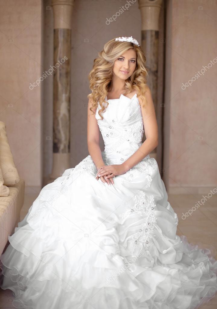 Attractive young smiling bride woman in wedding dress. Beautiful