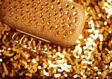 Fashion golden womens accessory. Luxurypurse on yellow sequins s clipart