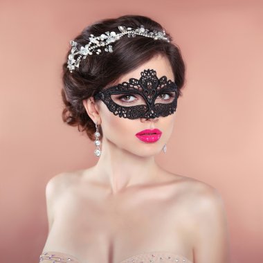 Elegant hairstyle. Beauty fashion Girl in black veil mask. Masqu