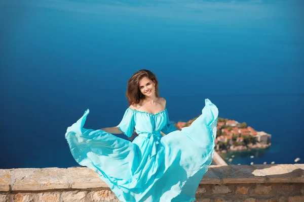 Schöne Mädchen in wehendem Kleid. glücklich lächelnde junge Frau genießen — Stockfoto