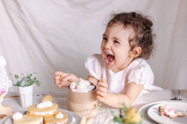 Bir fincan çay ve pastayla küçük bir kız