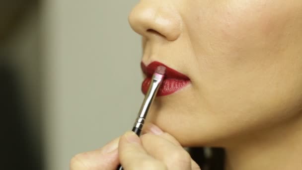 Applying red lipstick with brush — Stock Video