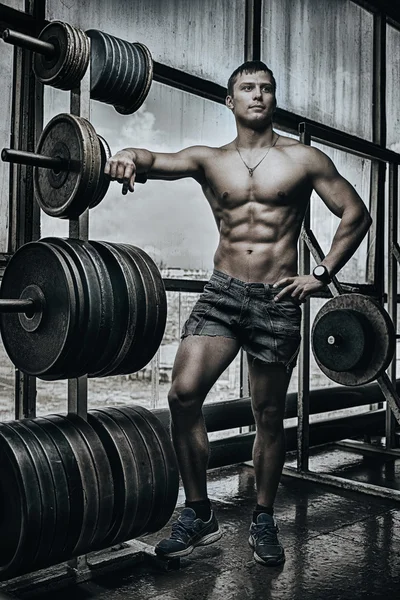 Athlete in old rusty gym — Stock Photo, Image