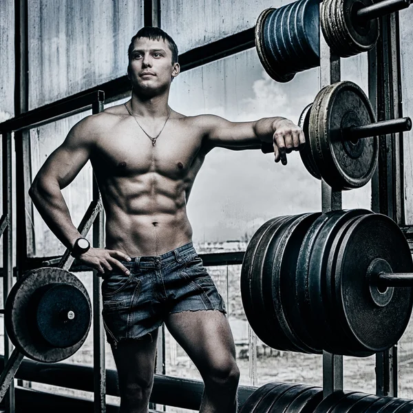 Athlete in old rusty gym — Stock Photo, Image