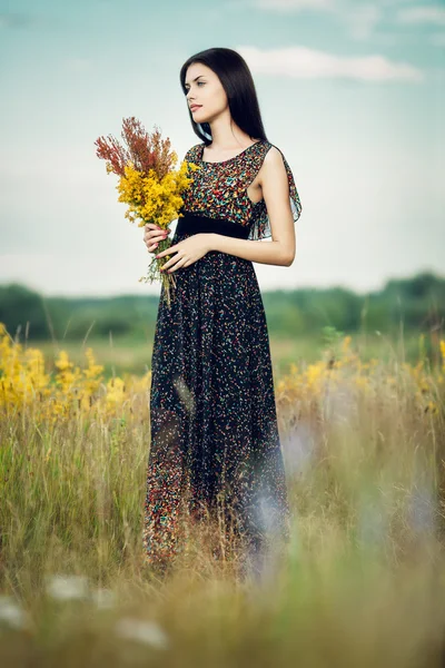 Brunette with flowers — Stock Photo, Image