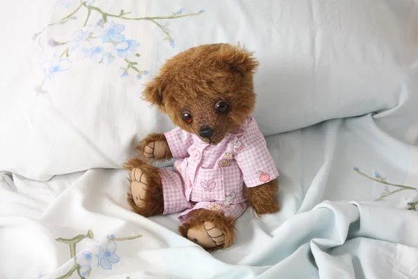 Cute teddy bear in pink pyjama — Stock Photo, Image