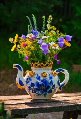 Bir çaydanlık kır çiçekleri buketi