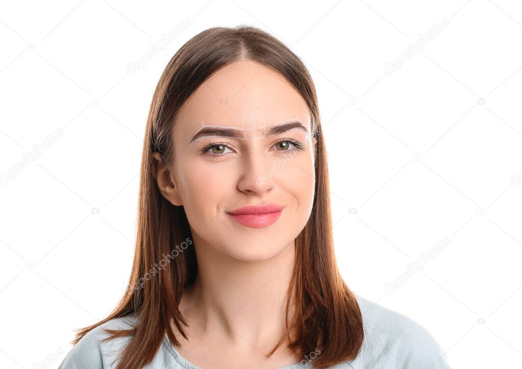 Young woman with marking for eyebrow correction against white background