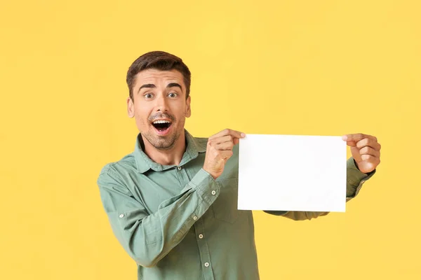Surprised Young Man Blank Paper Sheet Color Background — Stock Photo, Image