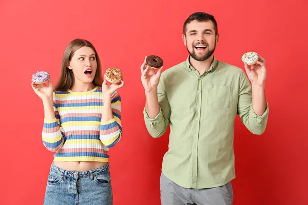 Casal Jovem Com Donuts Doces Fundo Cor — Fotografia de Stock