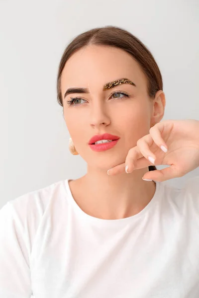 Young Woman Creative Eyebrows Light Background — Stock Photo, Image
