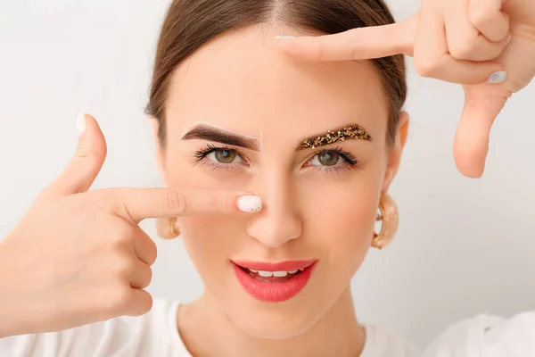 Young Woman Creative Eyebrows Light Background — Stock Photo, Image