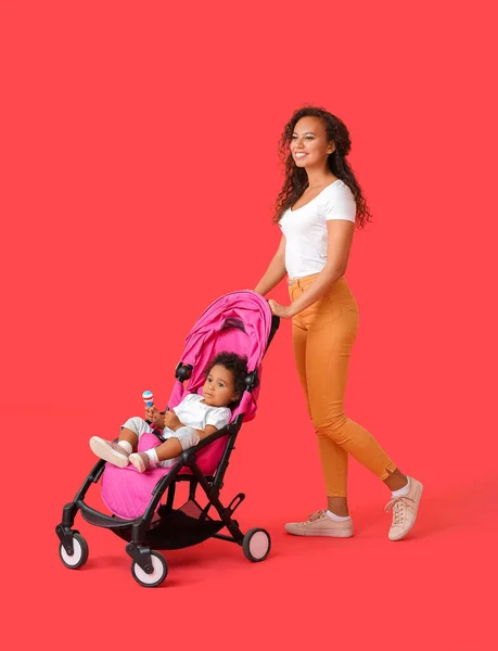 African American Woman Her Cute Baby Stroller Color Background — Stock Photo, Image