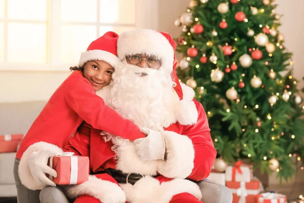 アフリカ系アメリカ人サンタクロースとともに可愛いです女の子に家に上のクリスマスEve — ストック写真