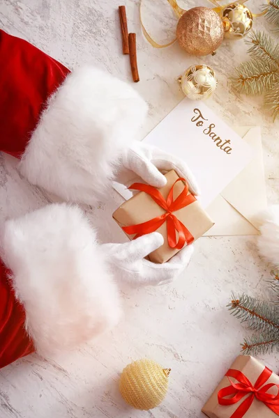 Santa with Christmas gift on white background