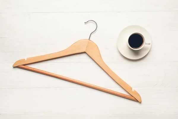 Clothes Hanger Coffee White Wooden Background — Stock Photo, Image
