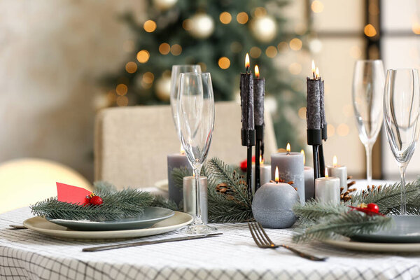 Beautiful table setting with Christmas decorations in living room