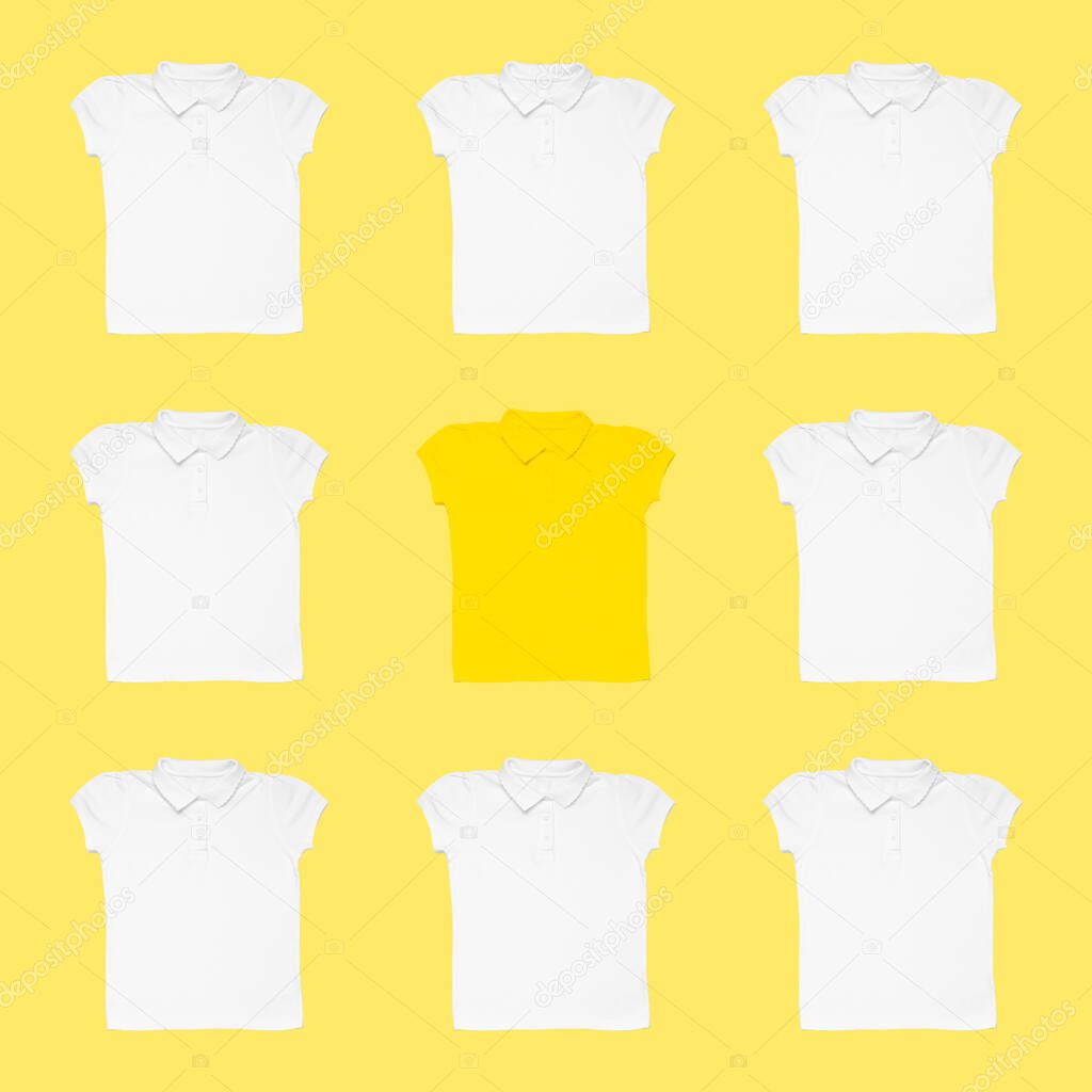 Yellow t-shirt among white ones on color background. Concept of uniqueness