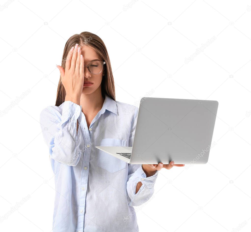 Stressed young businesswoman with laptop on white background