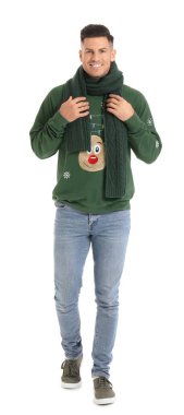 Beyaz arka planda kışlık elbiseli yakışıklı bir genç.