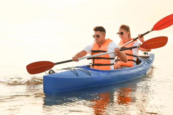 Young couple kayaking in river