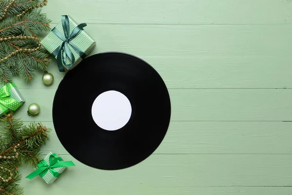 Vinyl disk and Christmas decor on color background