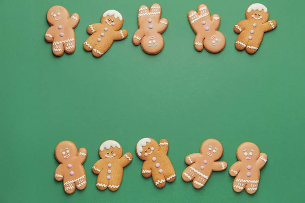 Tasty gingerbread cookies on color background