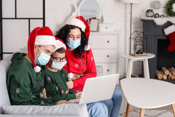 Family with laptop celebrating Christmas at home due to coronavirus epidemic