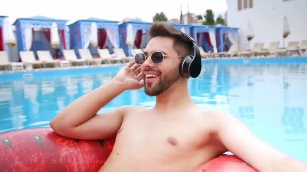 Young Man Listening Music While Relaxing Inflatable Ring Swimming Pool — Αρχείο Βίντεο