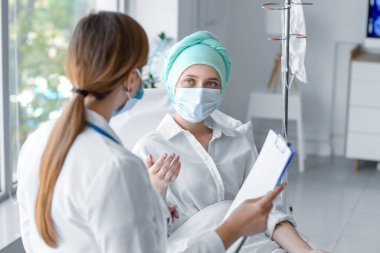 Doktor ve kadın klinikte kimyasal terapi görüyorlar.