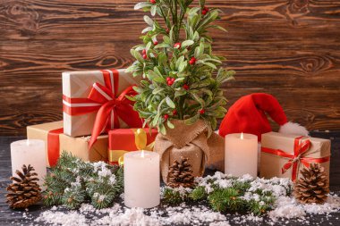 Tahta arka planda ökseotu bitkisi olan güzel bir Noel kompozisyonu