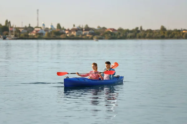 Young couple kayaking in river