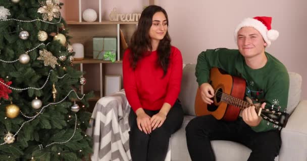 Happy Young Couple Playing Guitar Home Christmas Eve — Stock Video