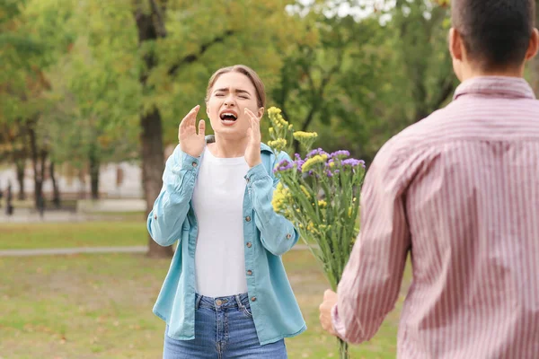 Man Giving Flowers His Allergic Girlfriend Outdoors — Stock Photo, Image