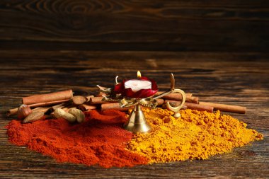Ahşap arka planda Divaly kutlamaları için baharatlı Diya lambası