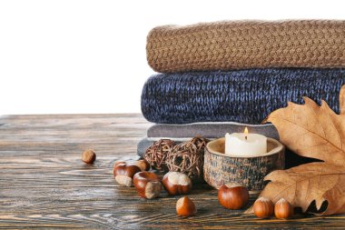 Masadaki sonbahar kıyafetlerini beyaz arkaplana karşı stil et