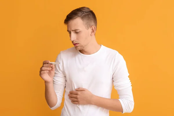 Young Man Measuring His Temperature Color Background — Stock Photo, Image