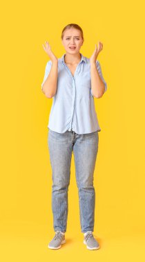 Renkli arka planda stresli genç bir kadın