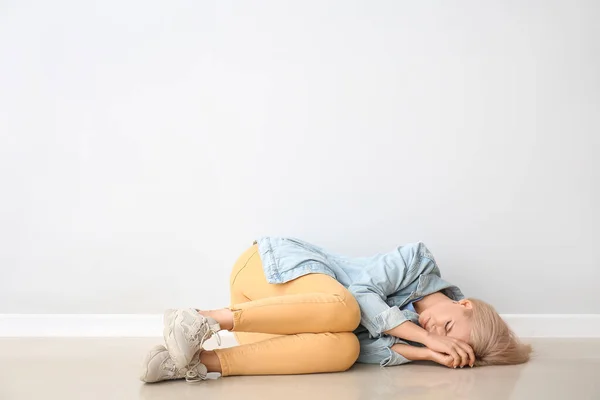 Stressed Young Woman Lying Light Wall — Stock Photo, Image