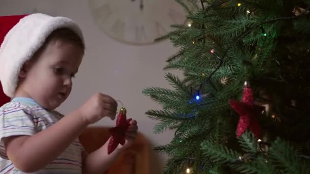 Little Baby Boy Decorating Christmas Tree Home — Stock Video