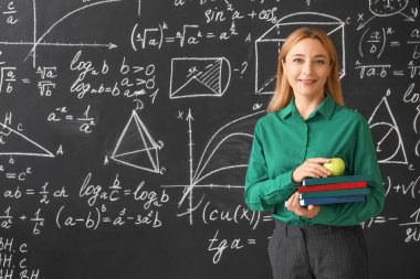 Sınıfta tahtanın yanında olgun matematik öğretmeni.